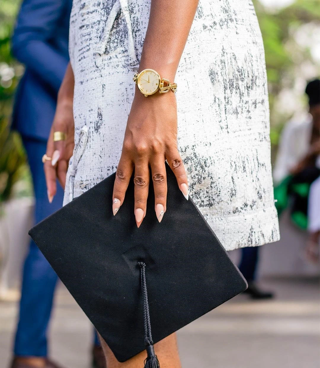 photoshoot of a graduand of KU focusing on nails and cap