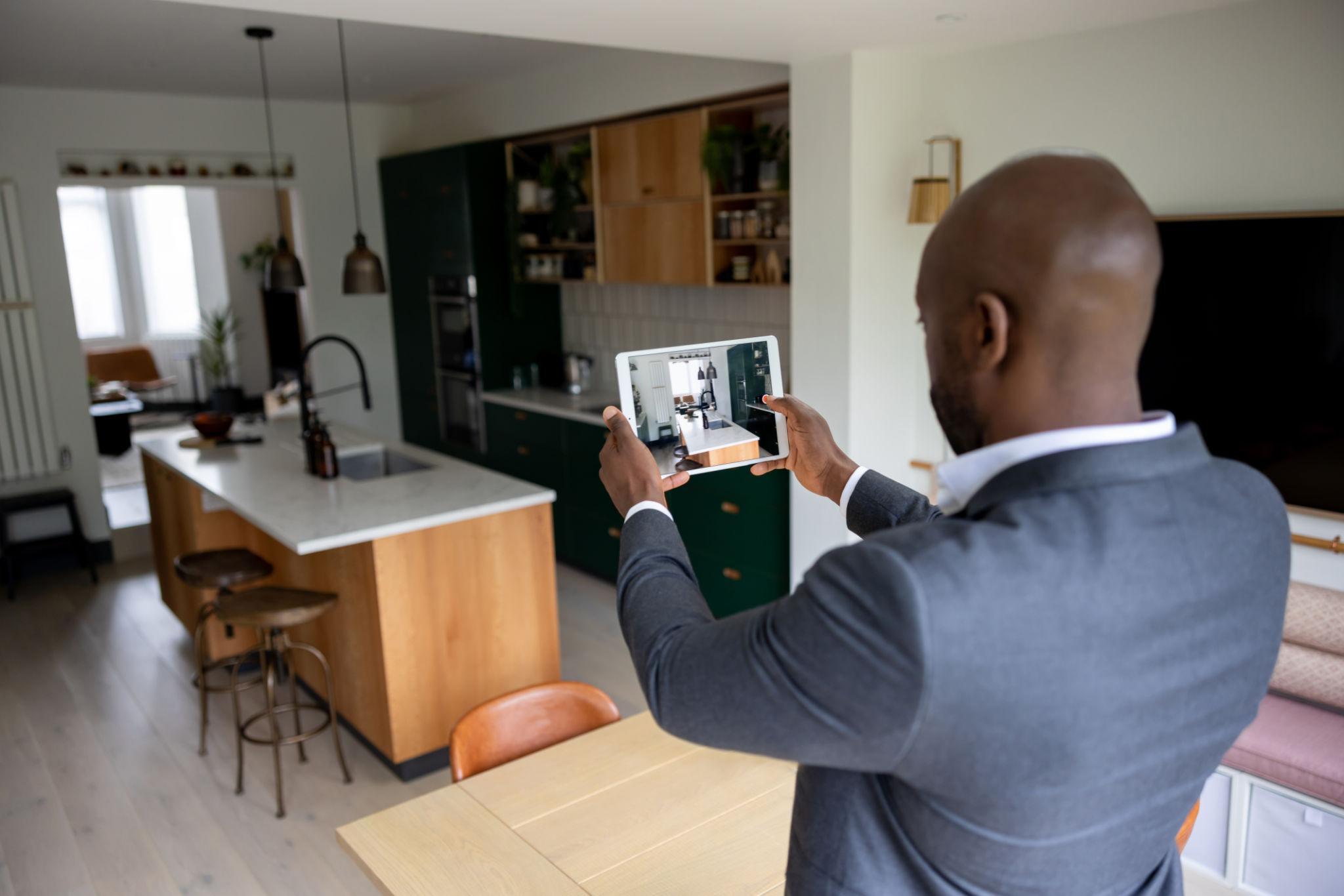 Image of a sales person taking photos of a house on sale in kenya