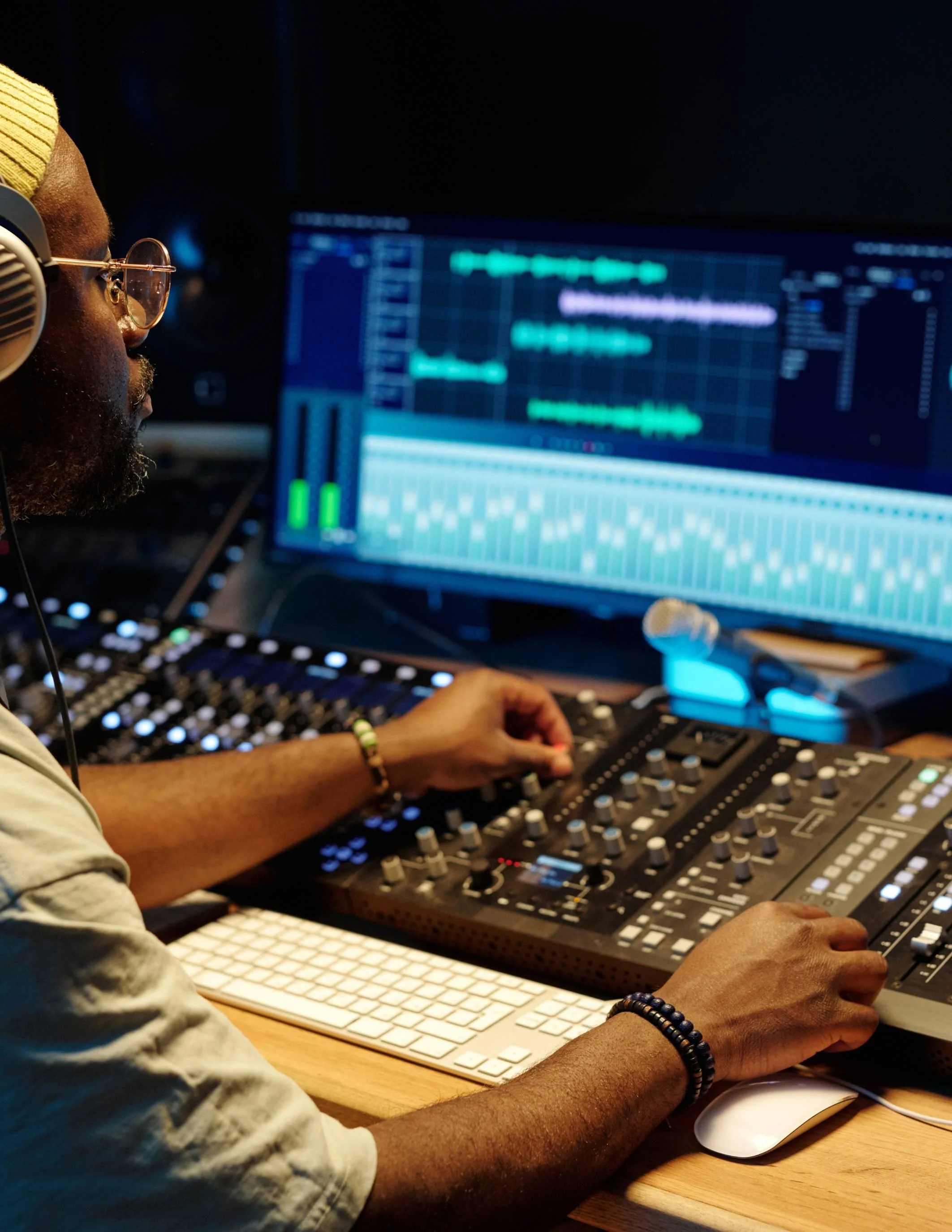 Audio engineer mixing sound effects and background music for cinematic influencer videos.