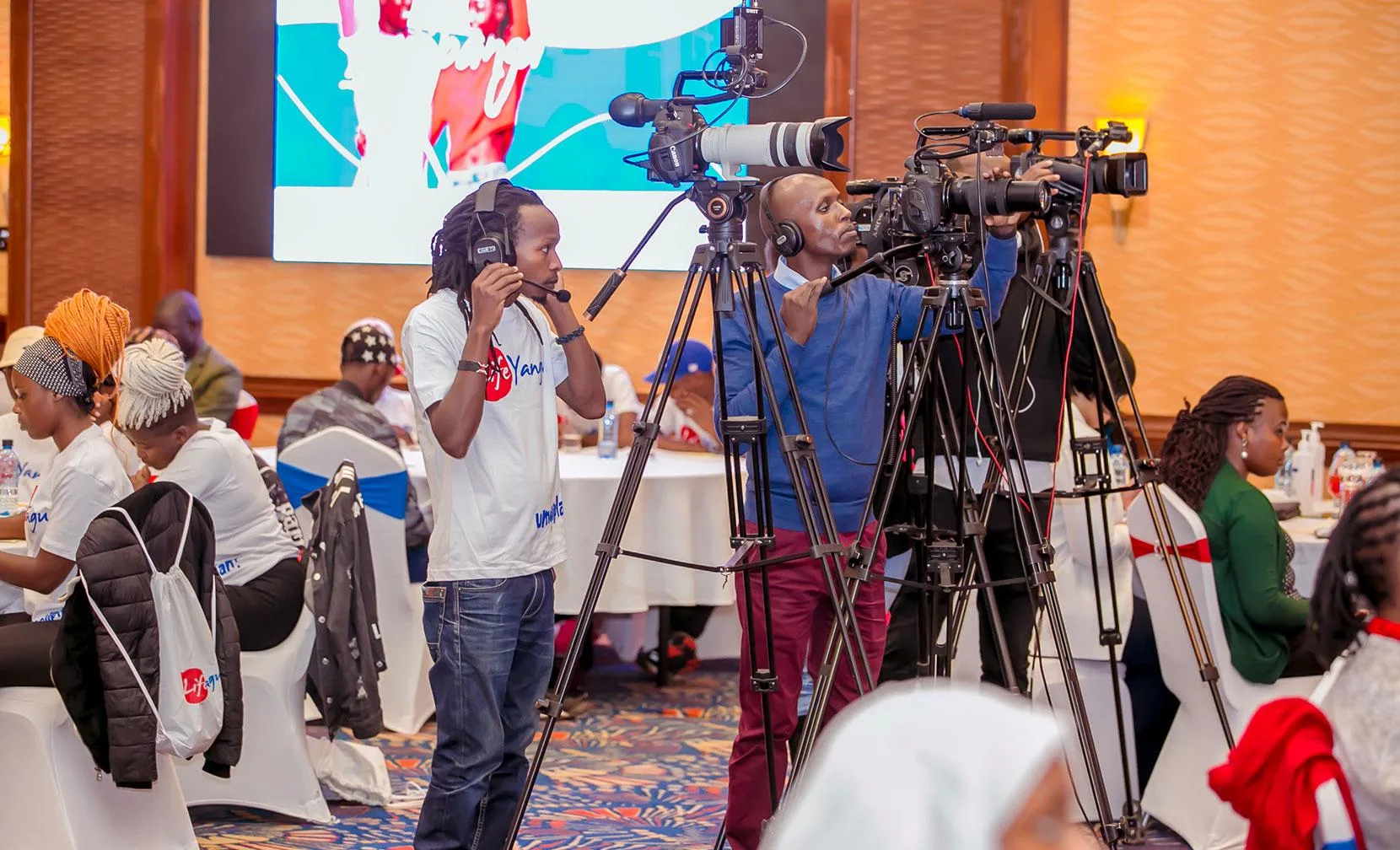 Professional photographer covering a corporate event in Nairobi using professional camera equipment