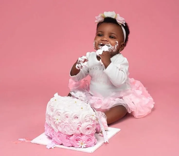 High-speed cake smash photography capturing baby throwing frosting during first birthday session