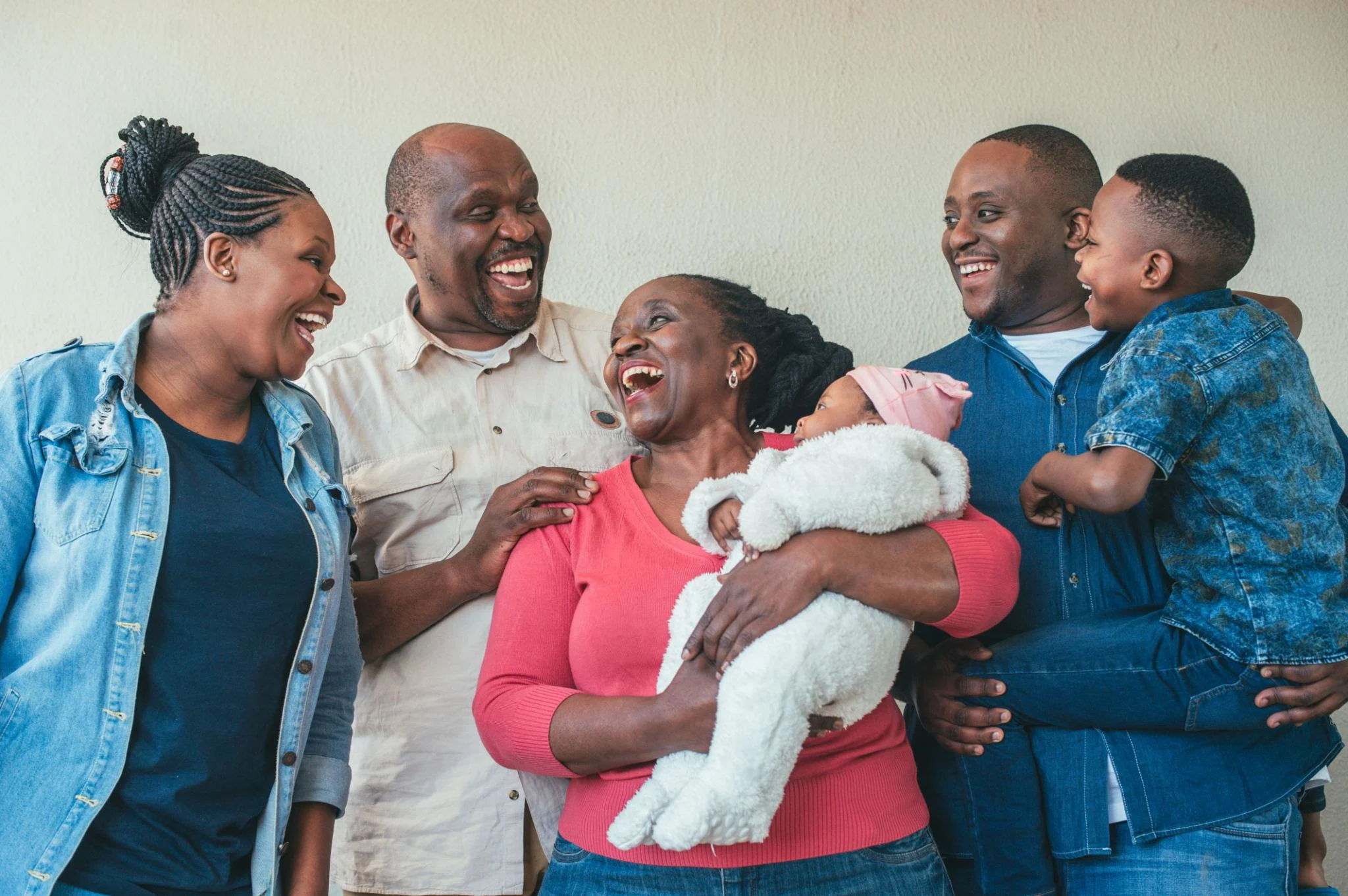 Multi-generational family laughing together during an outdoor lifestyle photoshoot