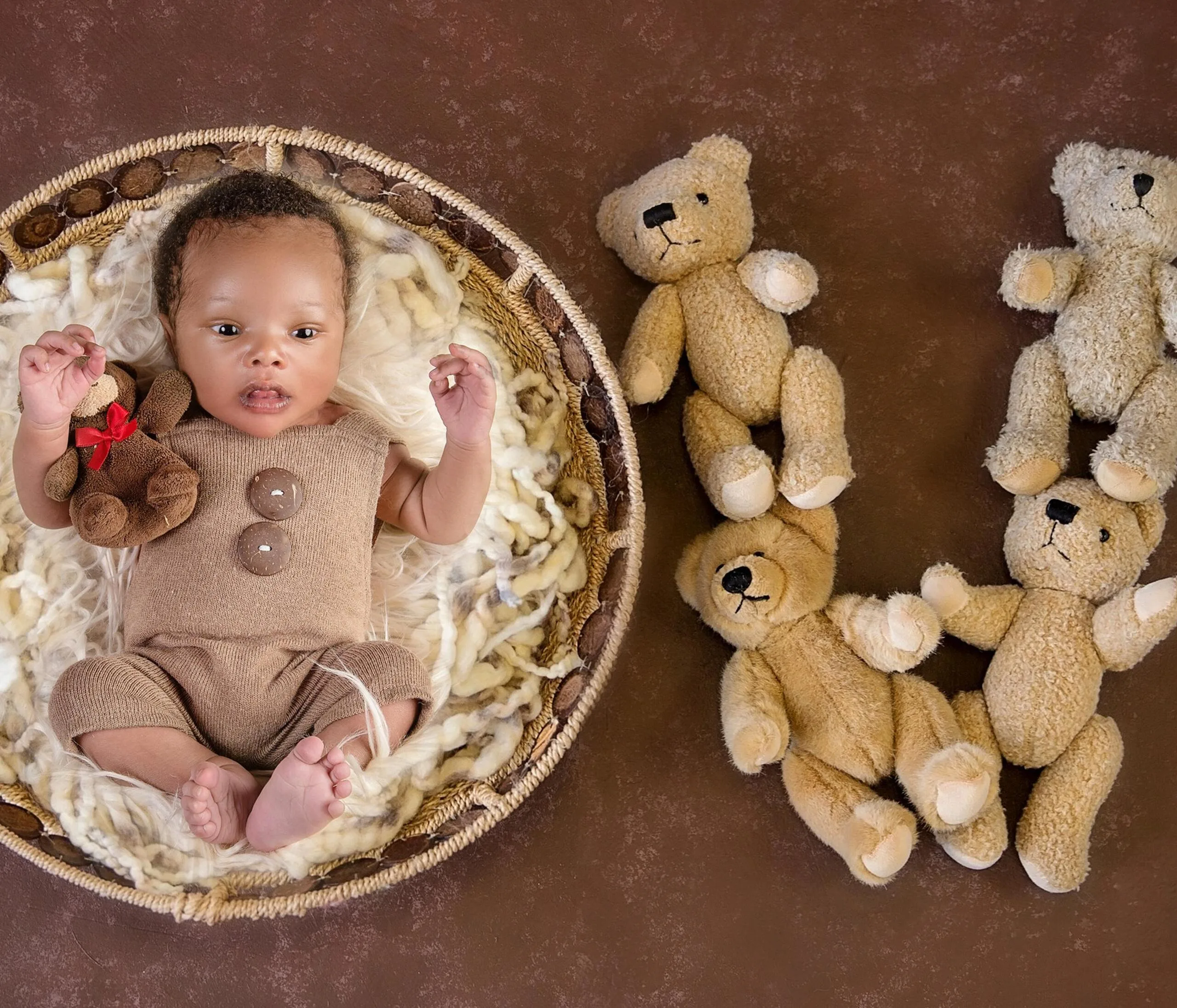 Creative newborn baby basket pose with teddy bears during a professional Kenya newborn photography session