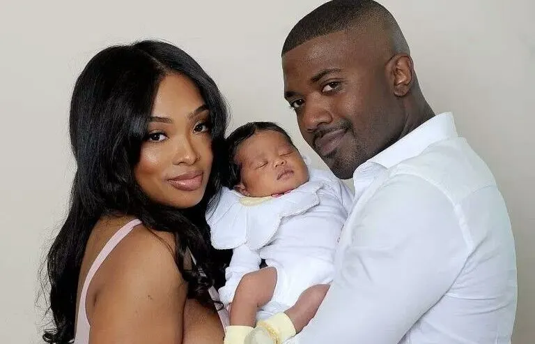 Parents holding newborn baby during a professional family newborn photoshoot in Nairobi