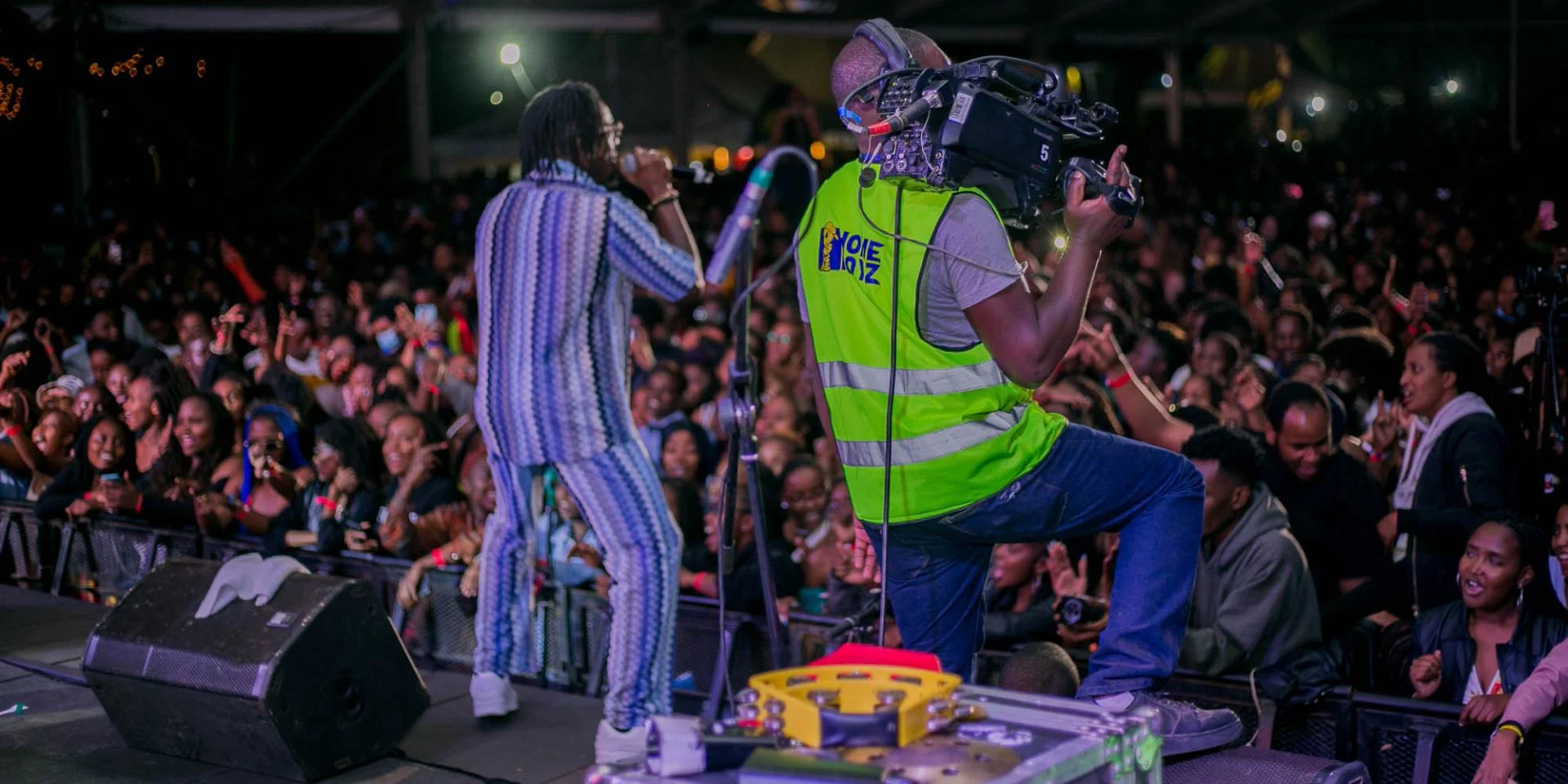 Multi-camera production team filming a large outdoor music festival in Kenya for broadcast and promotional use.
