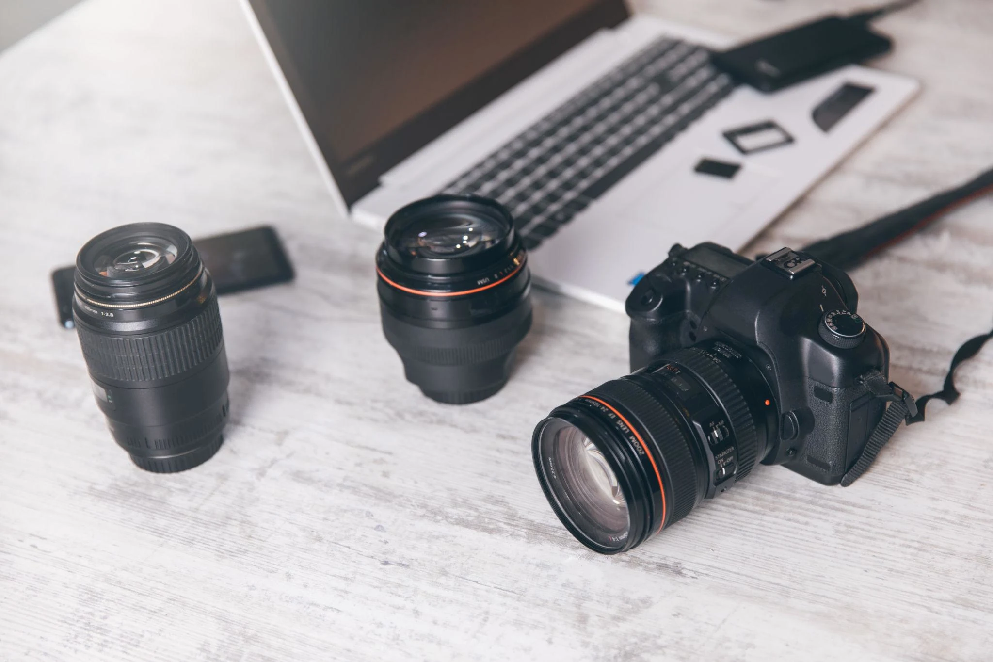 Professional photographer reviewing portfolio and camera equipment for commercial assignments