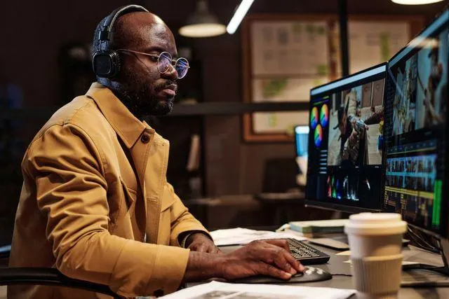 Professional video editor color grading 4K footage in a modern editing studio