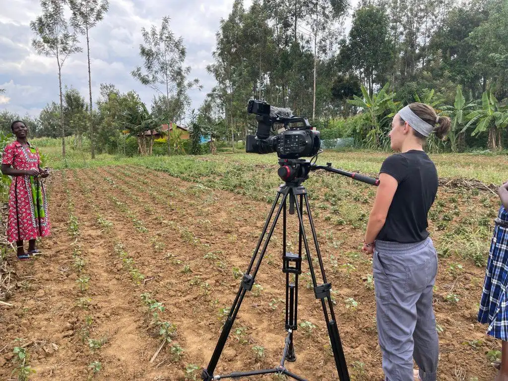 Documentary film crew recording interviews with community members during an NGO project in rural Kenya.