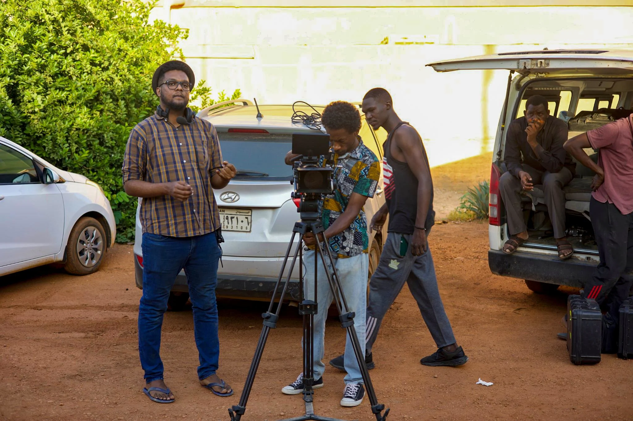 Professional videographer using a gimbal and cinema camera to record vertical social media content in Kenya.